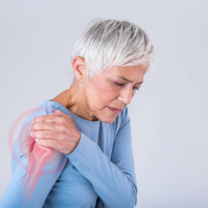 Woman experiencing frozen shoulder pain